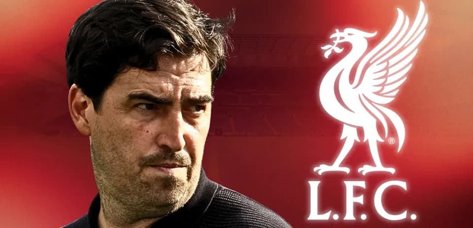 Coach with Liverpool FC logo in background