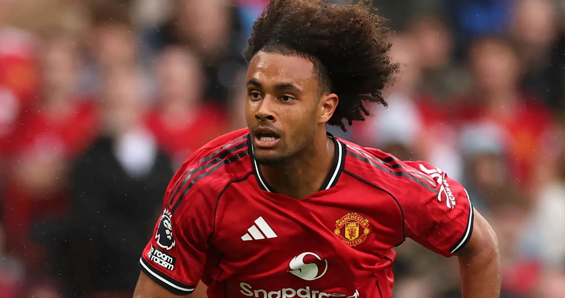 Player running on the pitch in Manchester United kit