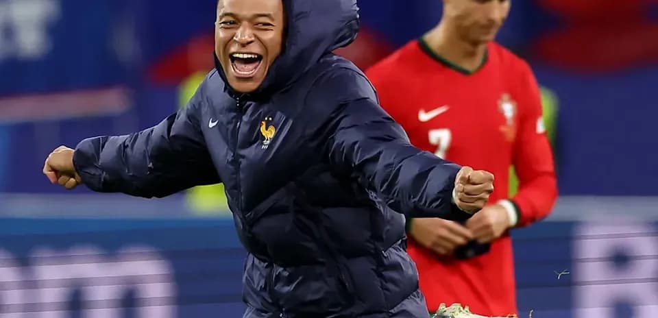 Kylian Mbappé celebrating during match, Cristiano Ronaldo in background