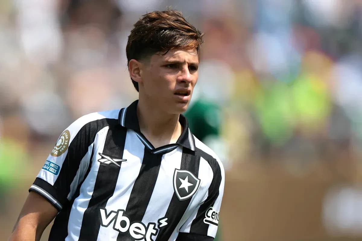 Player in black and white jersey on field Player in black and white jersey on field