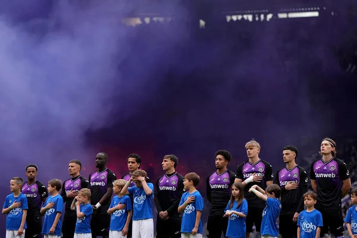Players and children standing for anthem with smoke