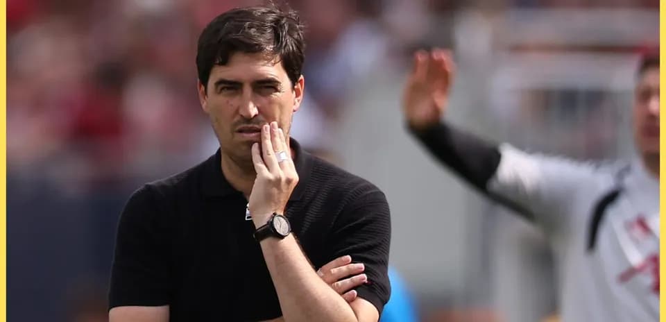 Coach observing match with thoughtful expression