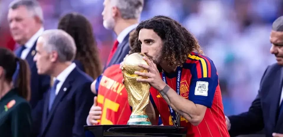 Player kissing World Cup trophy on podium