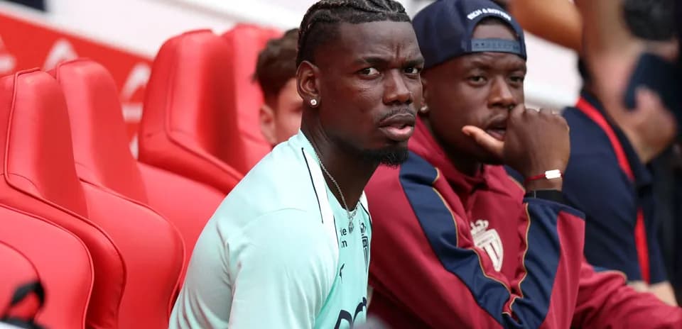 Two players sitting on red bench during match