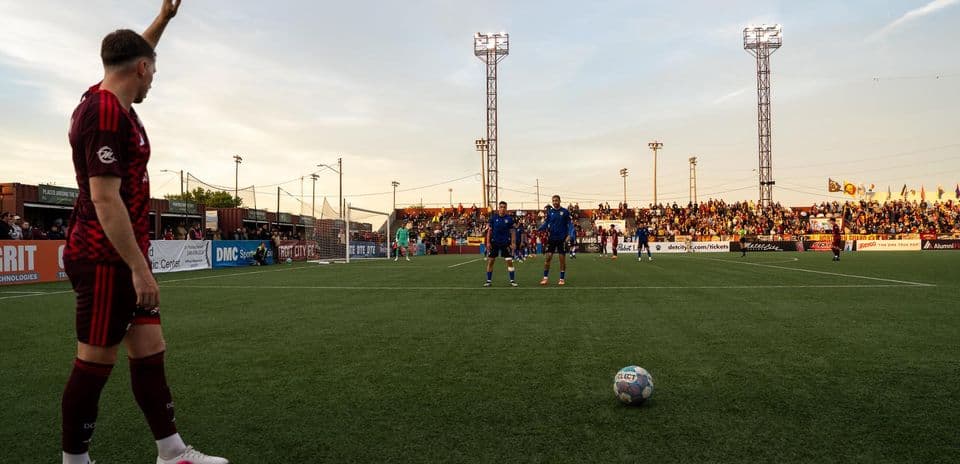 Detroit City player preparing for free kick