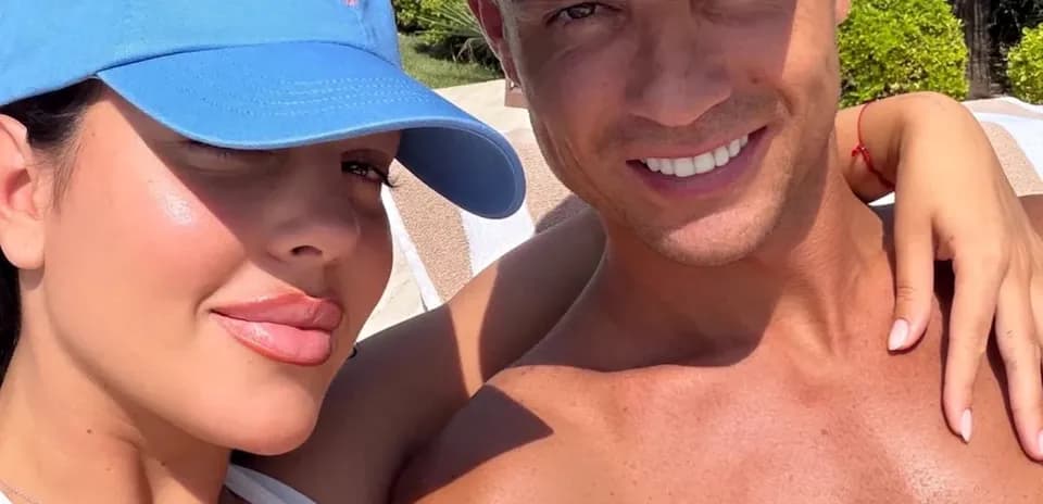 Couple posing for selfie in sunny outdoor setting