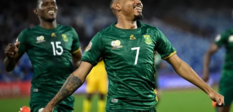 Player celebrating a goal with teammates on field