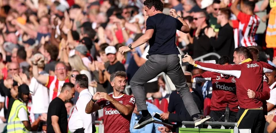Manager celebrating with fans after a goal