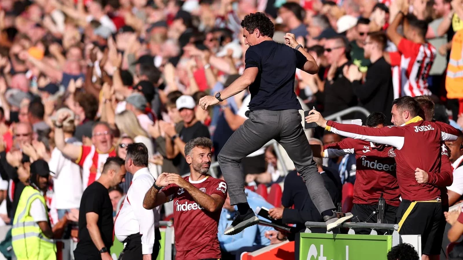 Manager celebrating with fans after a goal