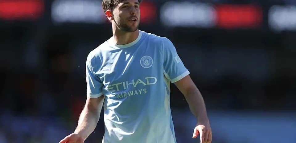 Player in light blue jersey on football pitch