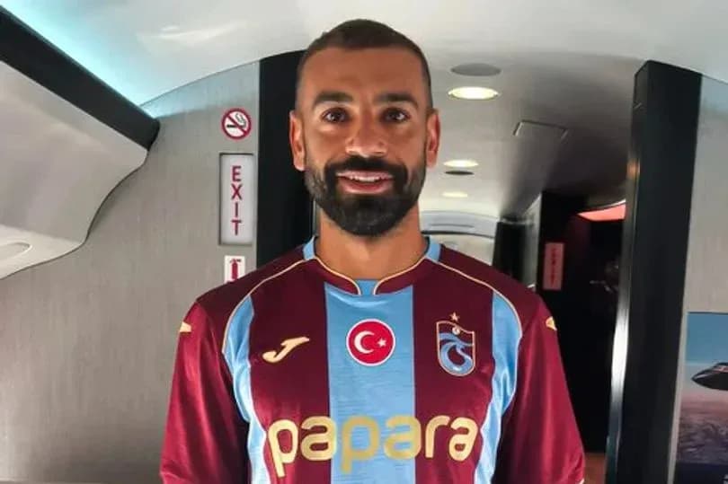 Player wearing Trabzonspor jersey inside aircraft