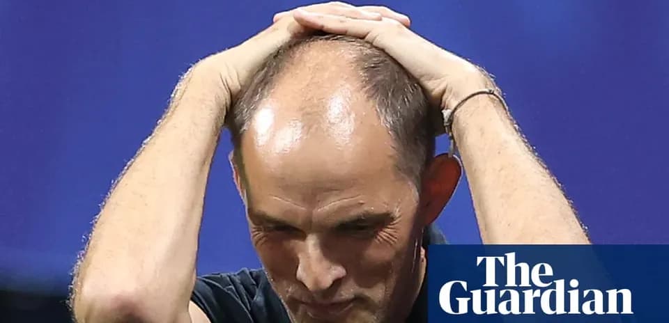 Coach holding head in frustration during match