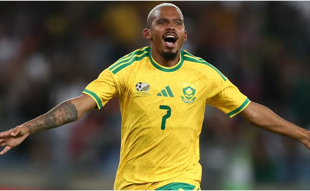 Player celebrating a goal in South Africa kit