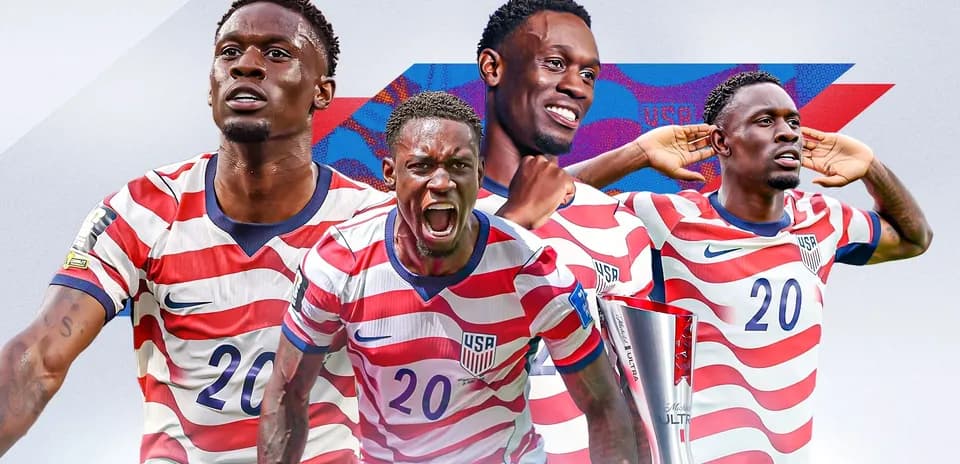 Player celebrating with trophy in USA kit