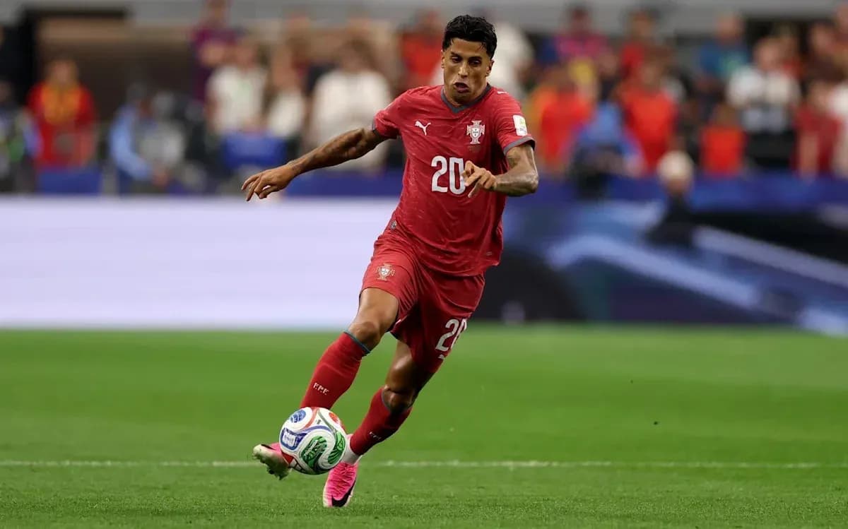 Player in red jersey dribbling the ball on field