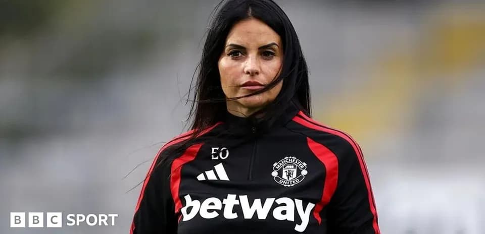 Coach wearing Manchester United training gear outdoors
