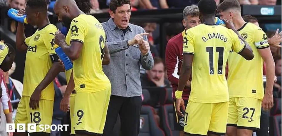 Brentford players and coach during match break