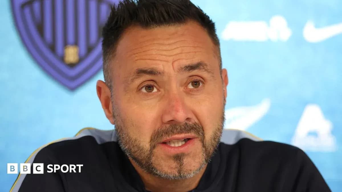 Manager speaking at press conference with backdrop