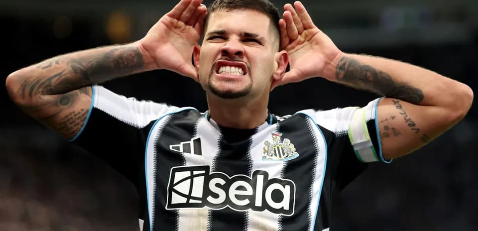 Newcastle player celebrating with hands on ears
