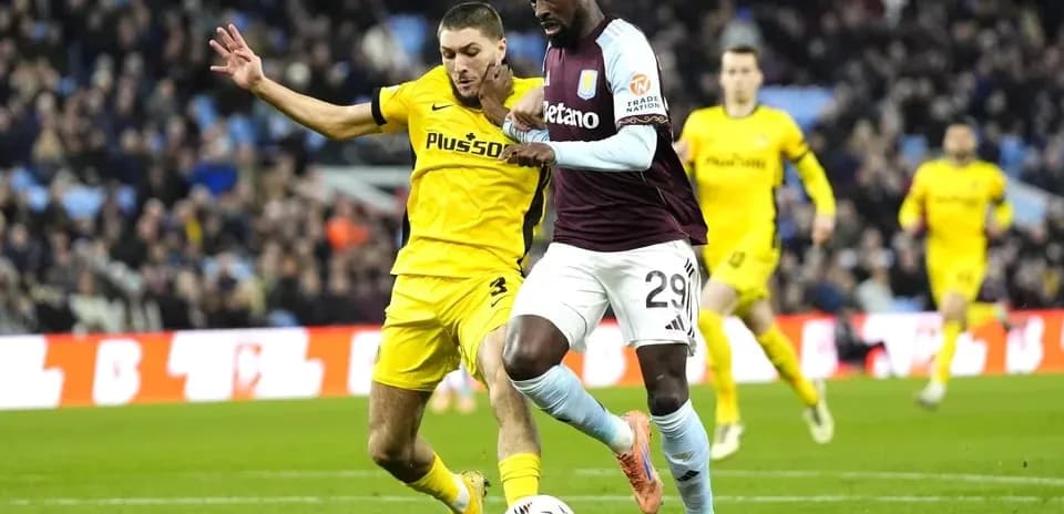Player dribbling past opponent during football match