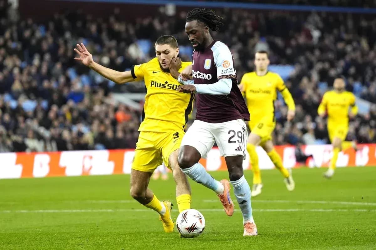 Player dribbling past opponent during football match