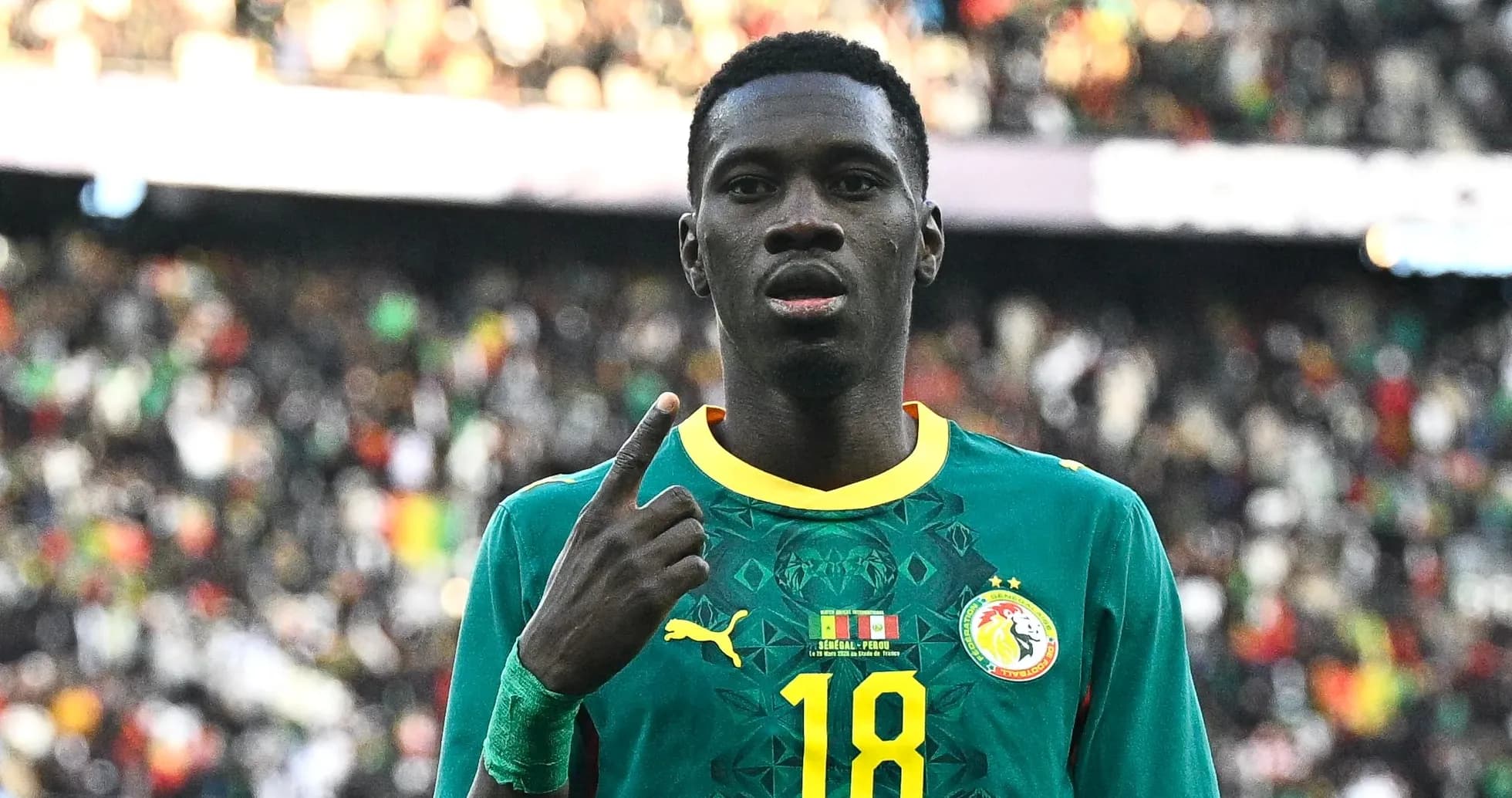 Player celebrating with raised finger in stadium