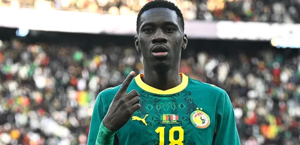 Player celebrating with raised finger in stadium
