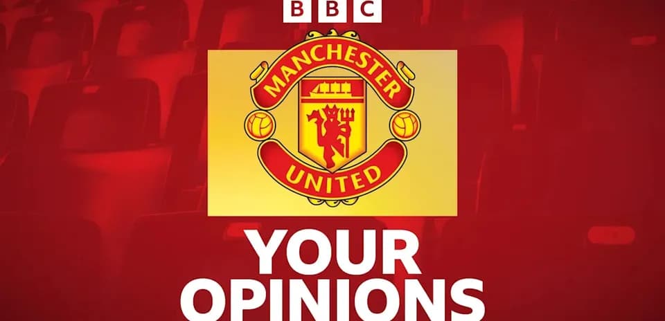 Manchester United logo with seating in background