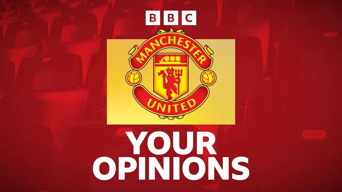 Manchester United logo with seating in background