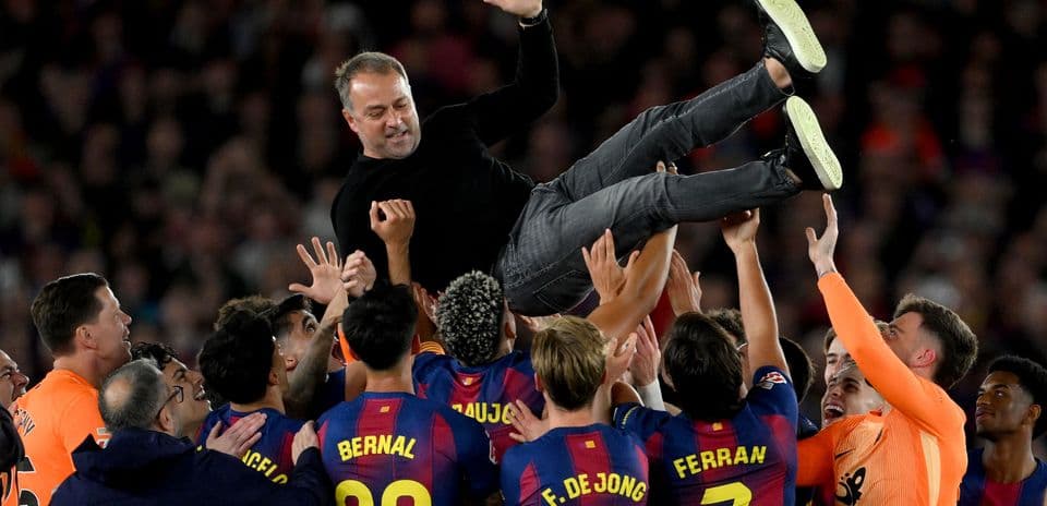 Barcelona players celebrating and lifting their coach