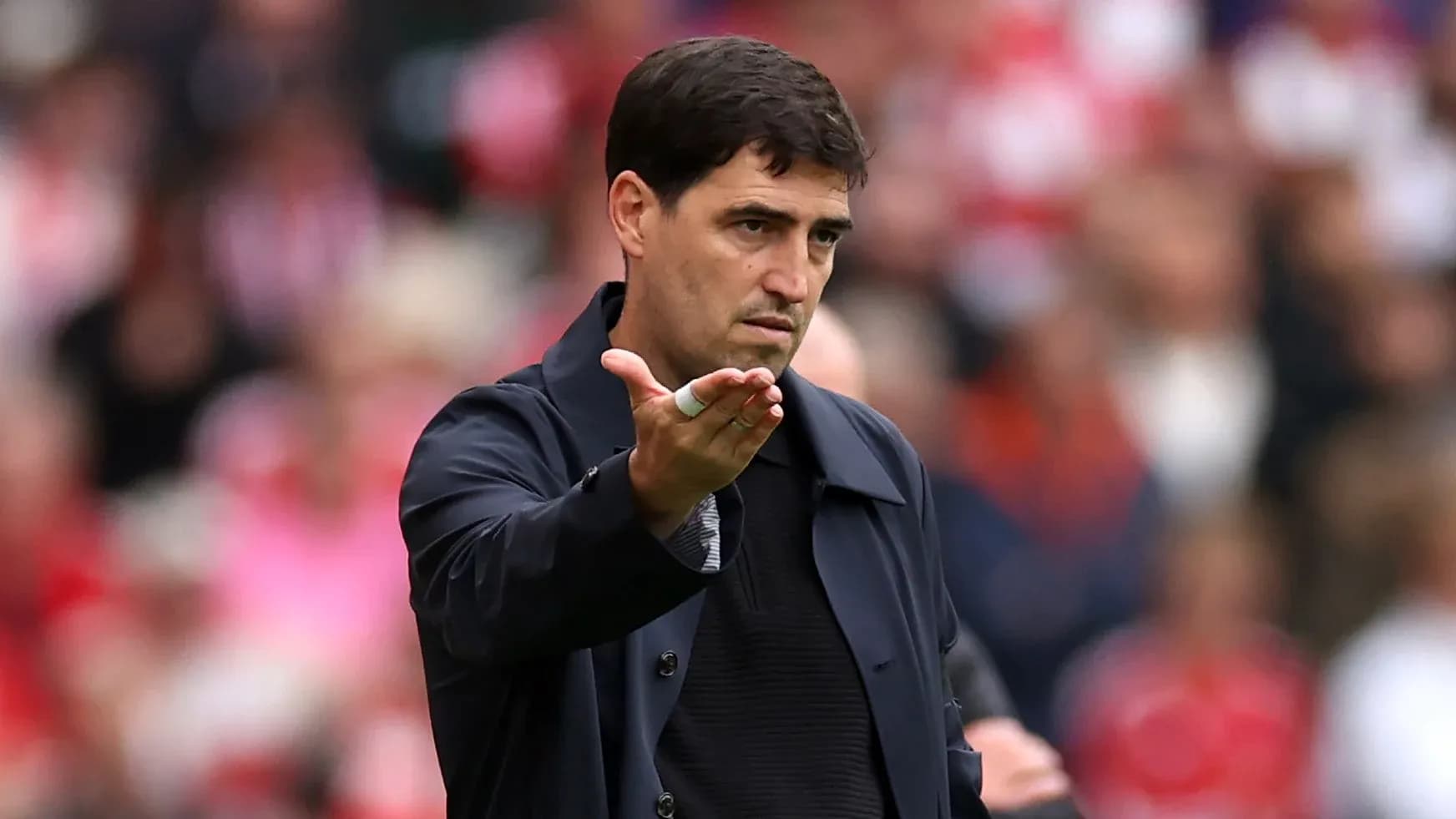 Coach gesturing during a match on the sidelines