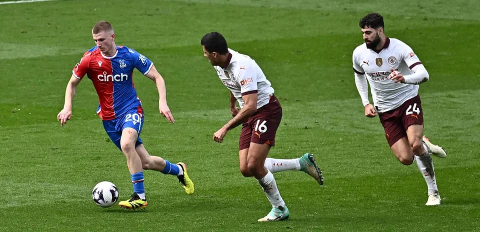 Player dribbling the ball with defenders chasing