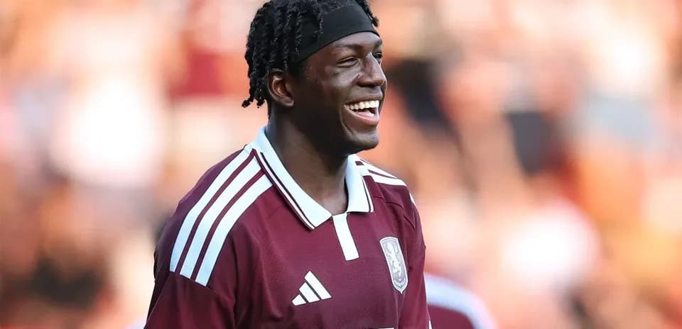 Player smiling during match in maroon jersey