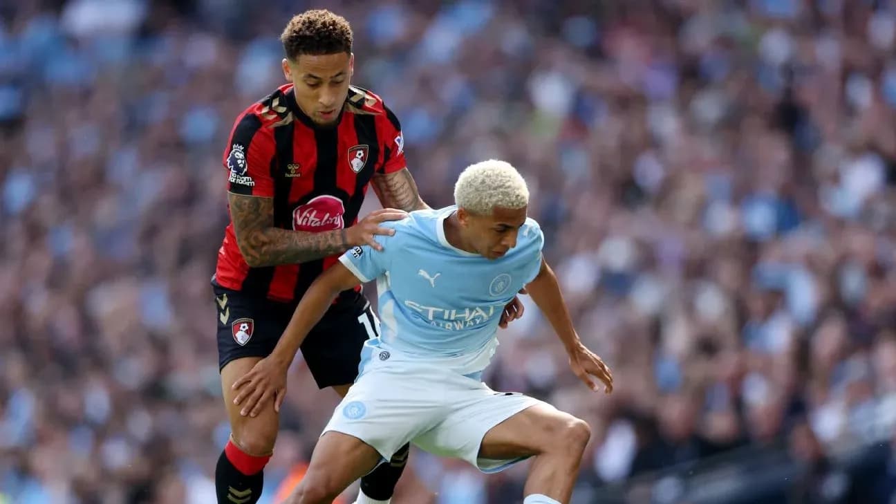 Bournemouth player challenges Manchester City player for ball