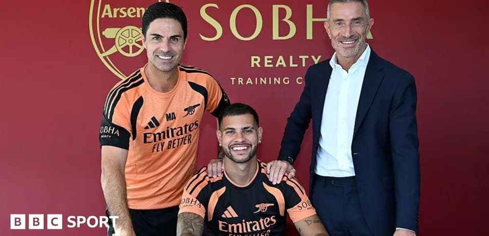 Manager and player signing contract at training facility