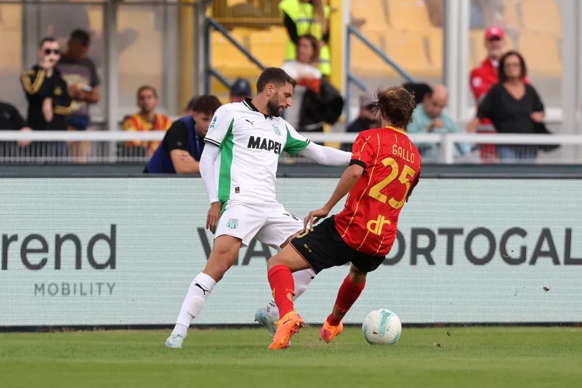 Sassuolo player tackling Lecce opponent on field