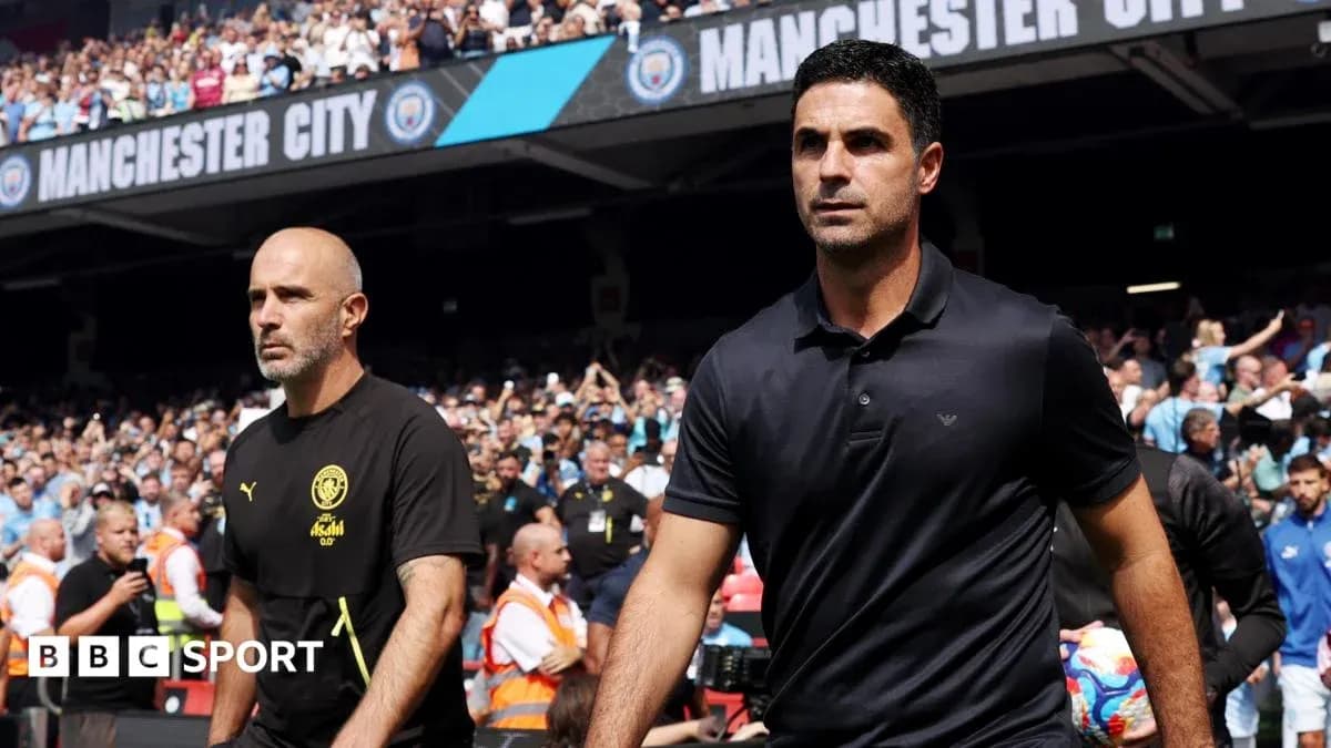 Two football managers walking onto the pitch