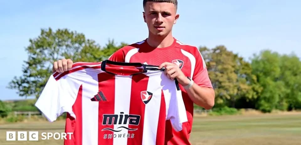 Player holding Cheltenham Town shirt during announcement