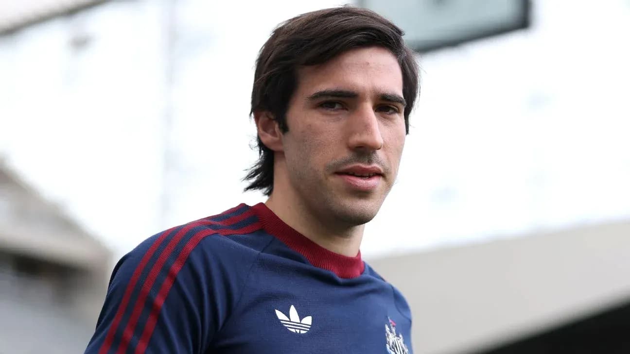 Football player posing in training kit outdoors