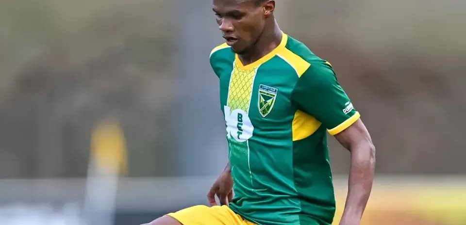 Player in green and yellow kit during match