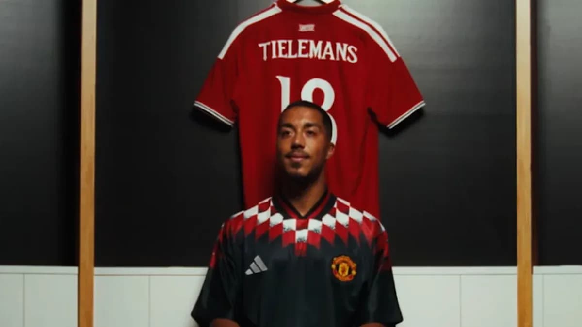 Player wearing Manchester United jersey in locker room
