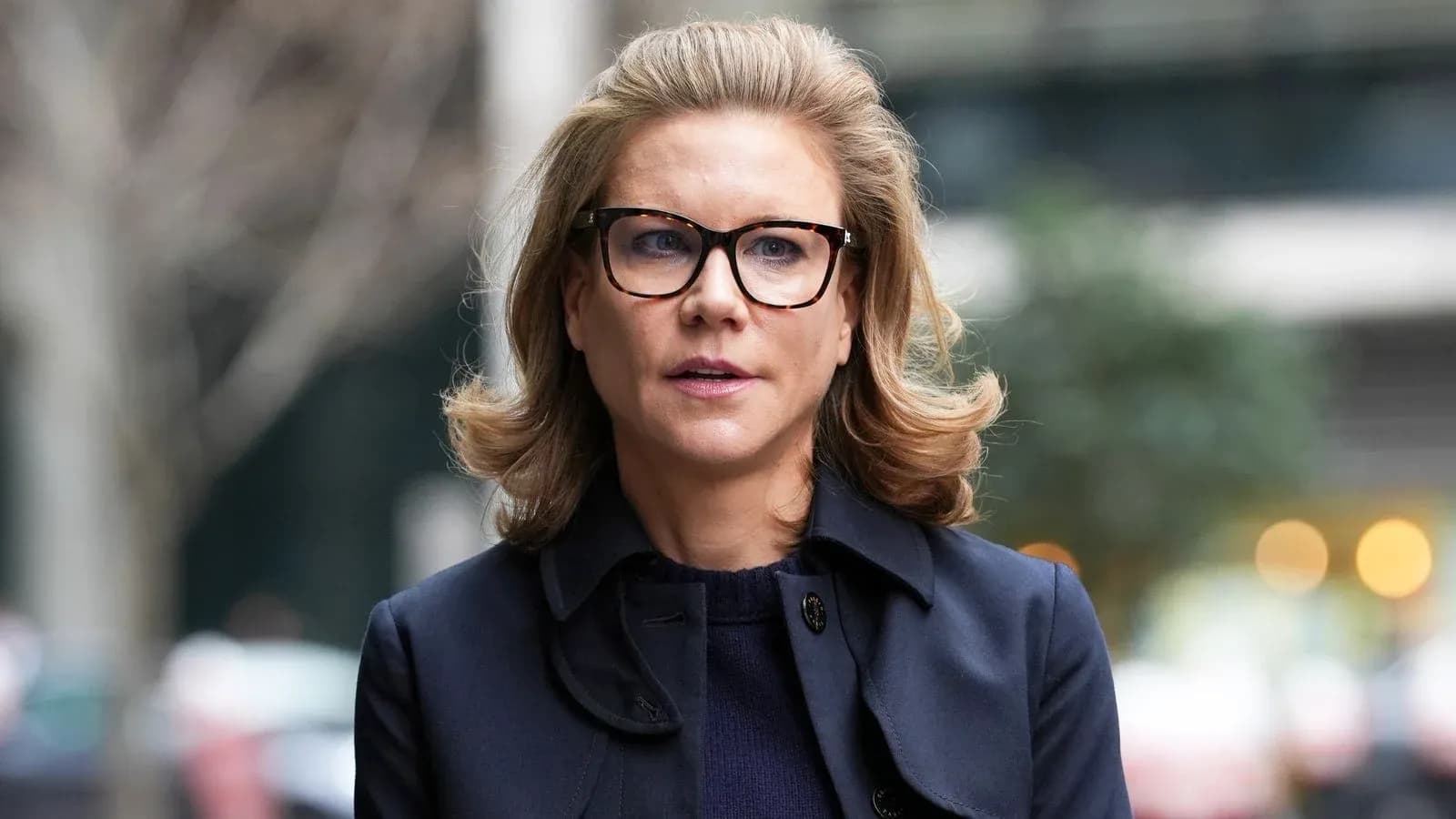 Woman with glasses walking in urban setting