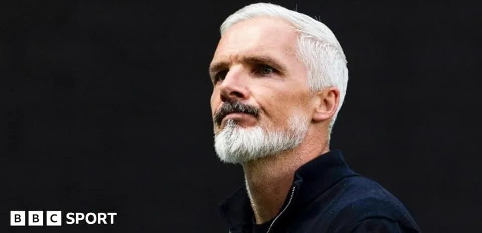 Man with white hair and beard looking thoughtfully