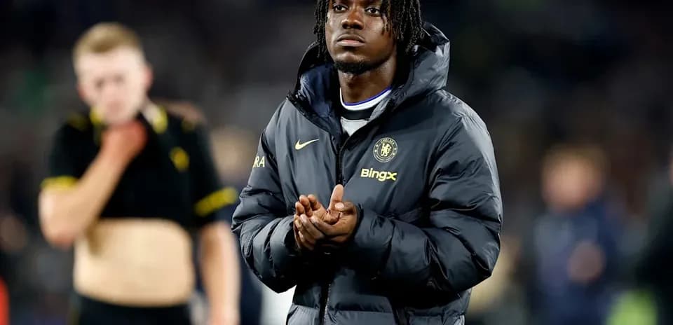 Player in Chelsea jacket applauding after match