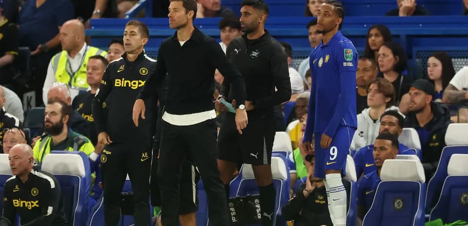 Coaches and players on the sidelines during match