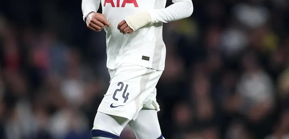 Player in Tottenham kit running with ball