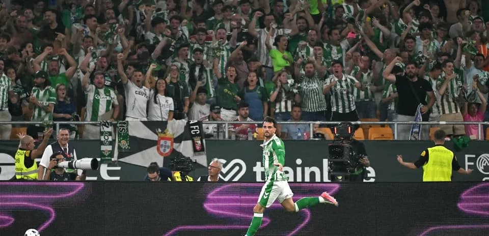 Player celebrating goal in front of cheering fans