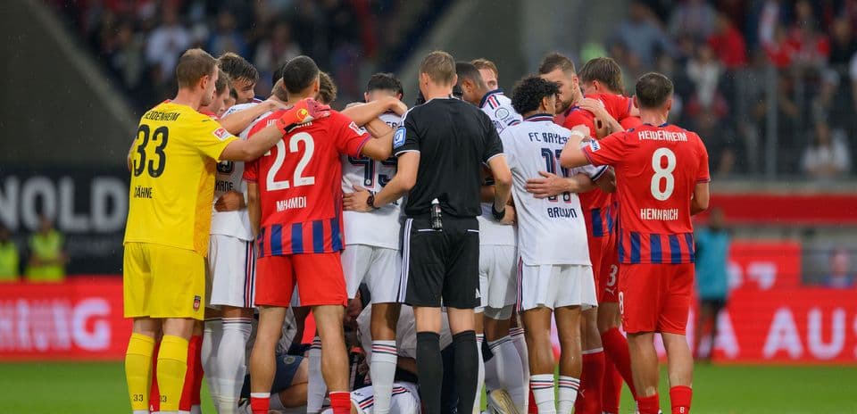 Players from both teams huddled together on the field