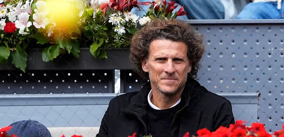 Person seated among flowers at tennis event