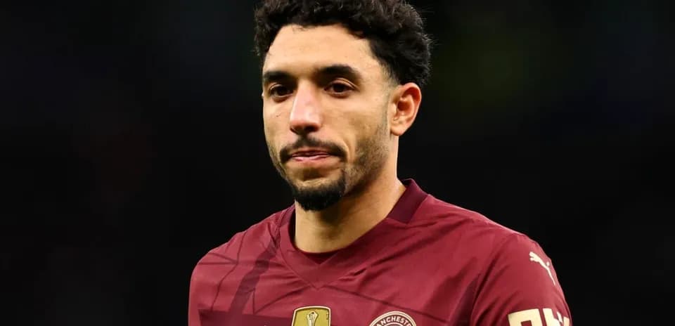 Player in maroon jersey walking on field